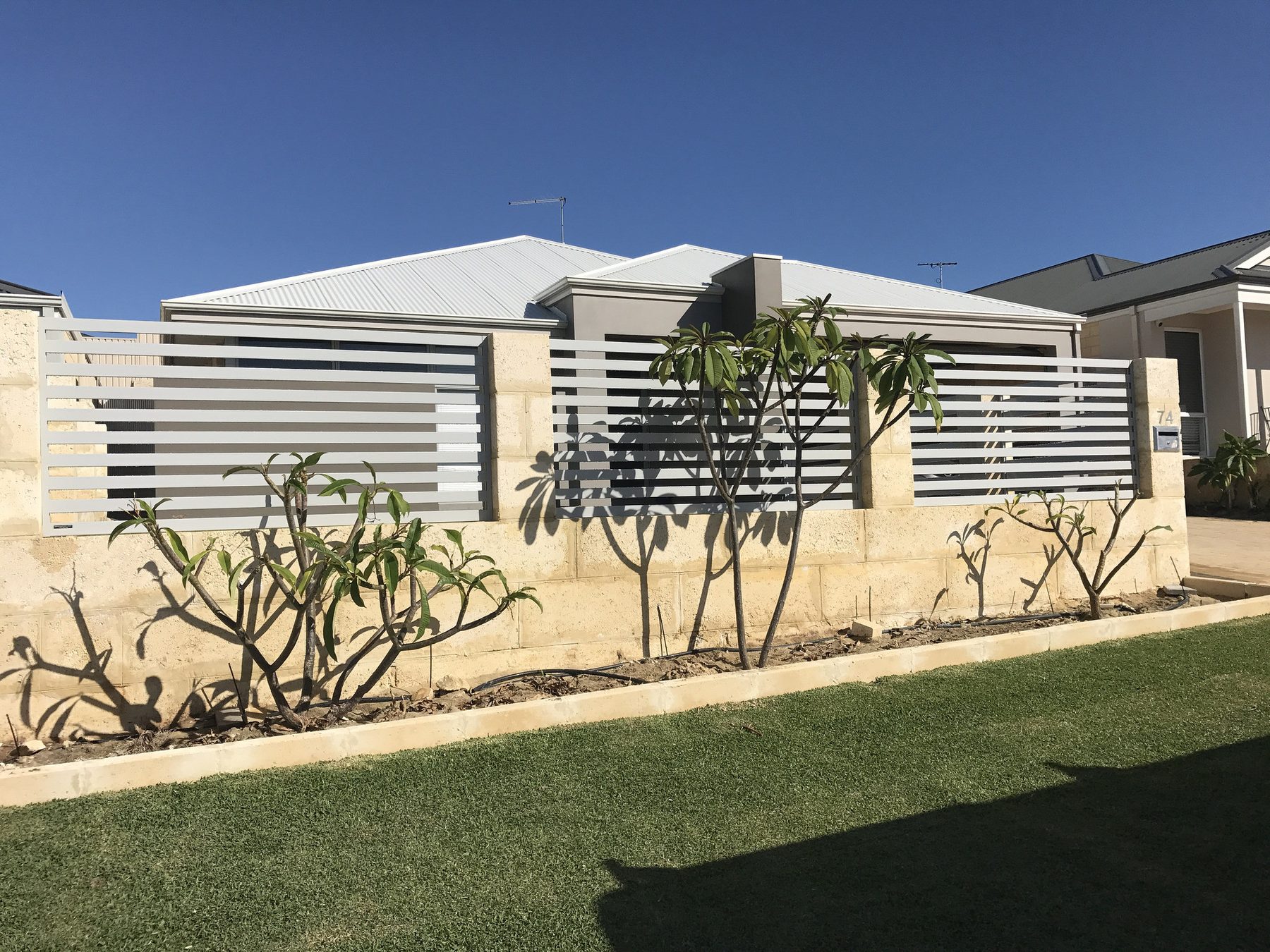 White aluminium slat fencing across a Perth front boundary