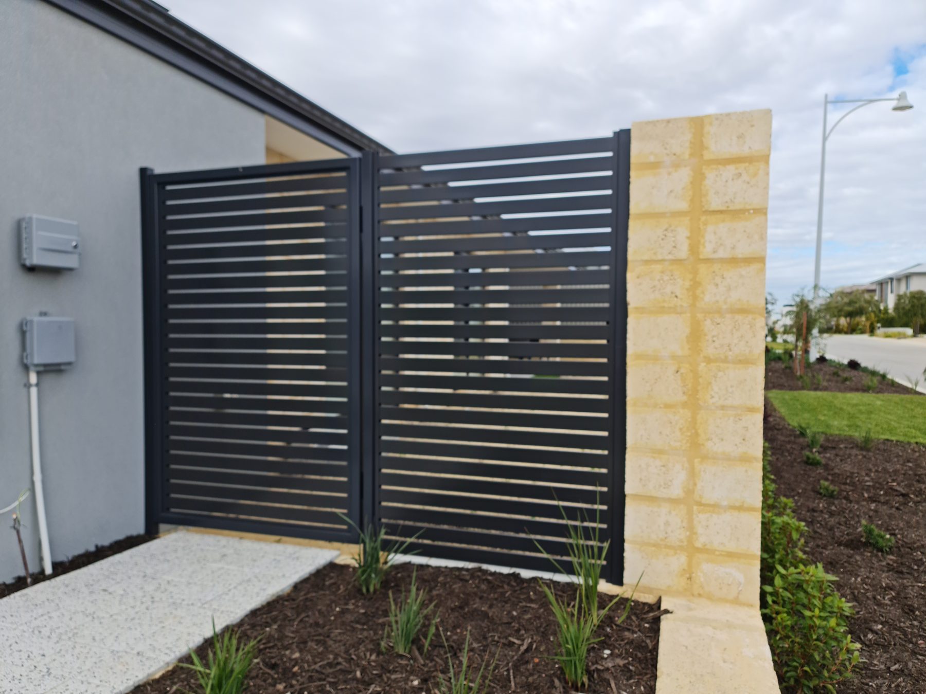 Charcoal aluminium slatted double gate installed in Perth