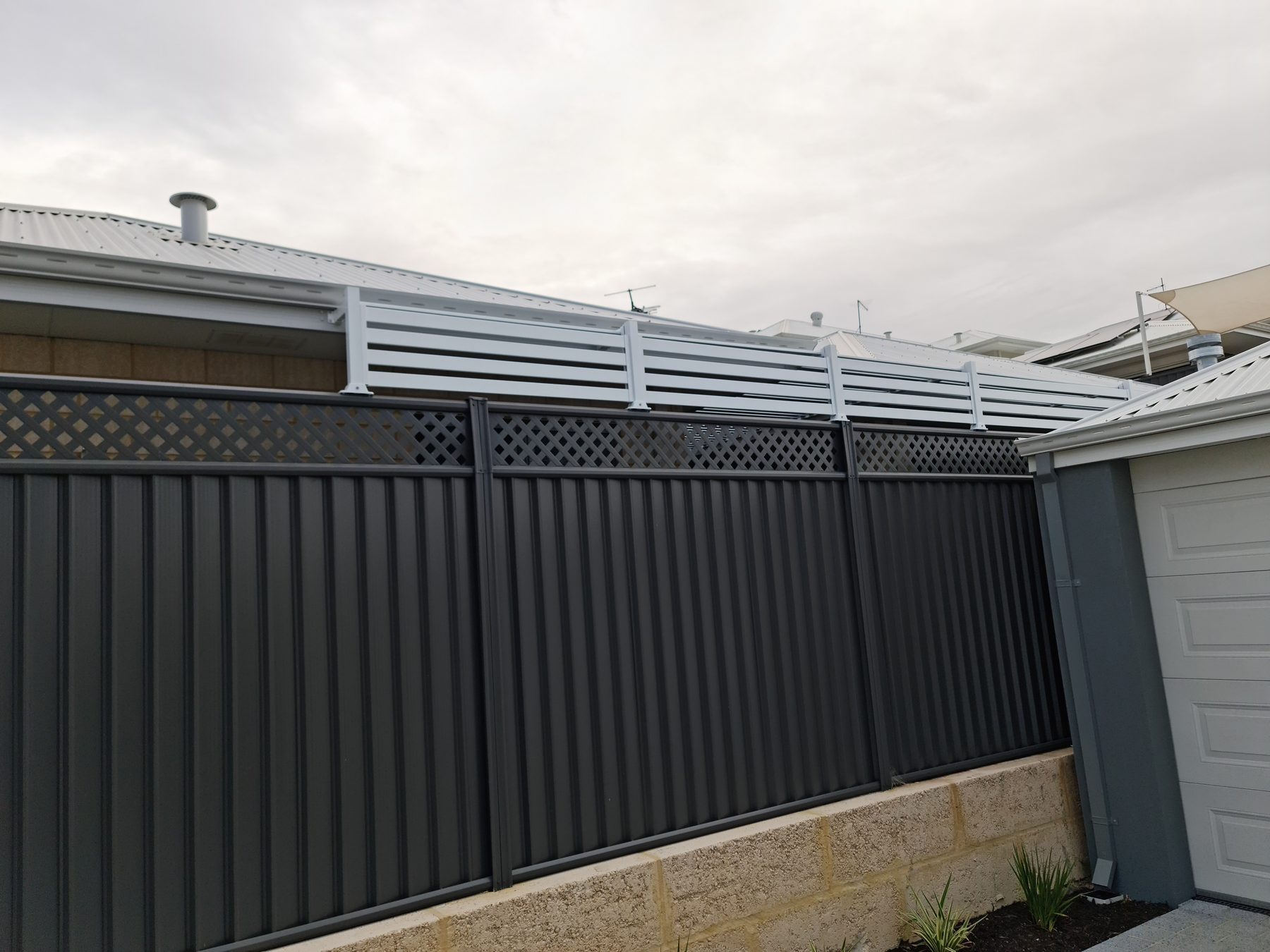 Colorbond fence with aluminium slat extension panel for added height, Perth
