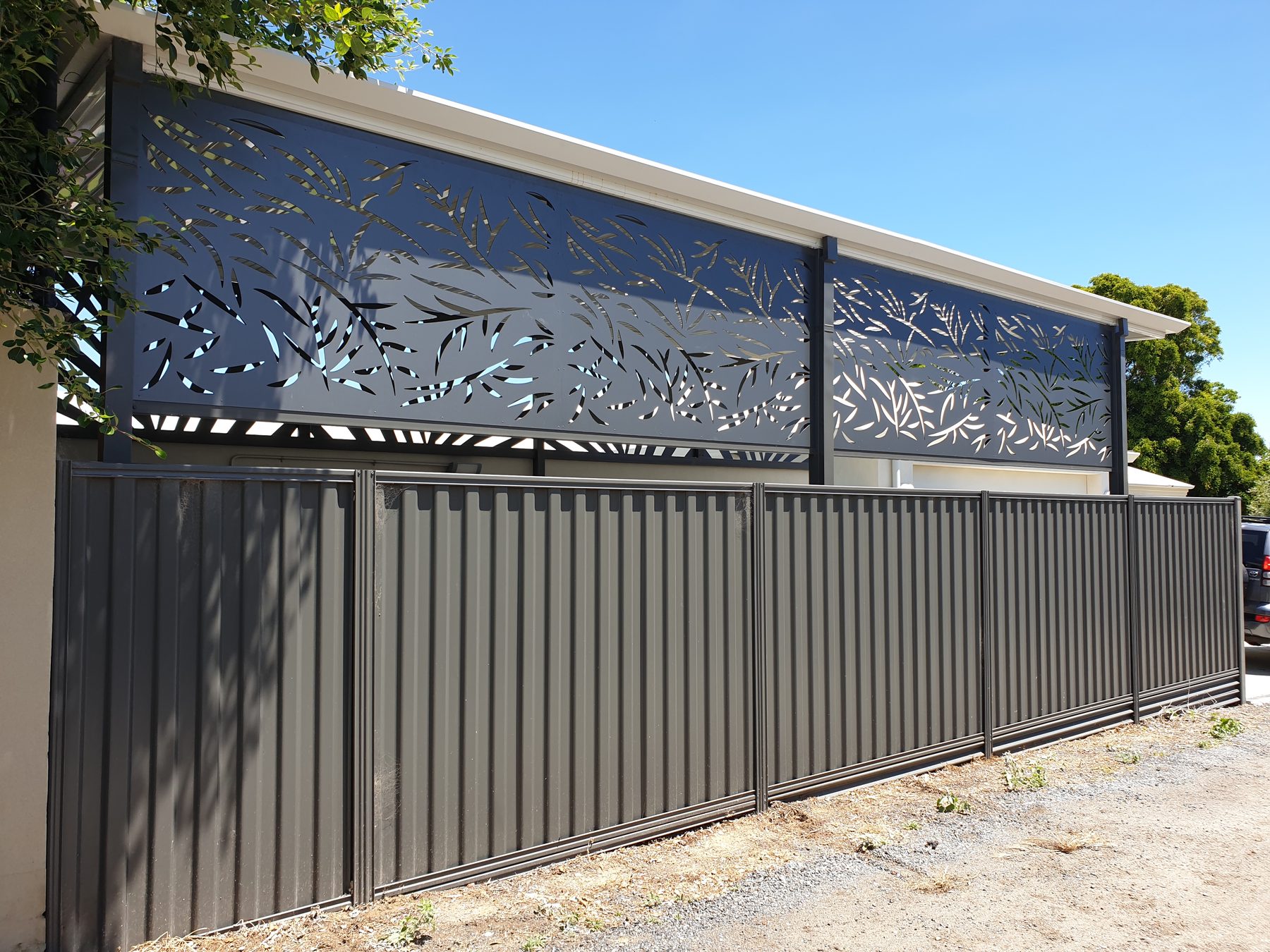 Leaf pattern laser cut screen adding height above a Colorbond fence in Perth