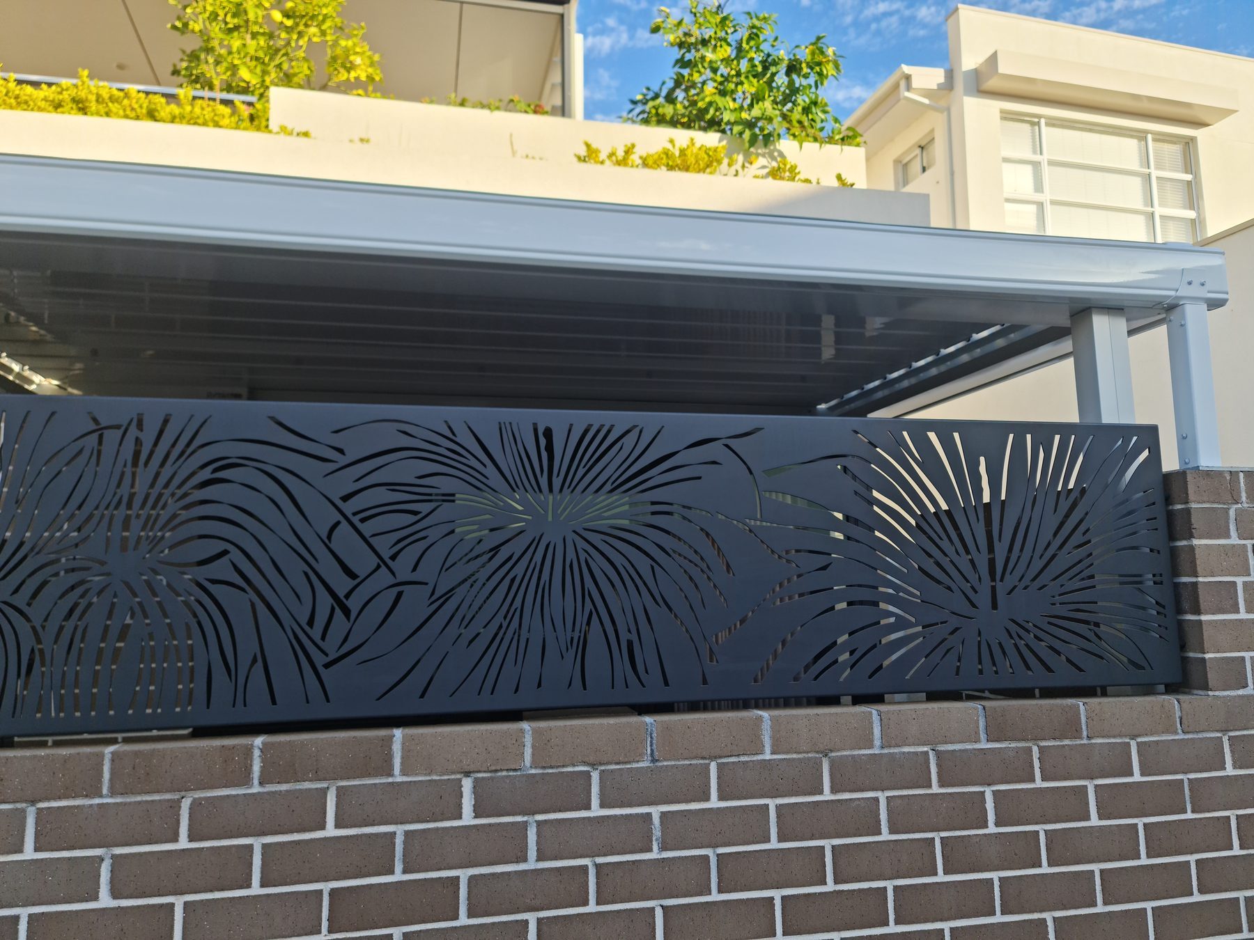 Firework pattern laser cut panel on a brick wall in Perth