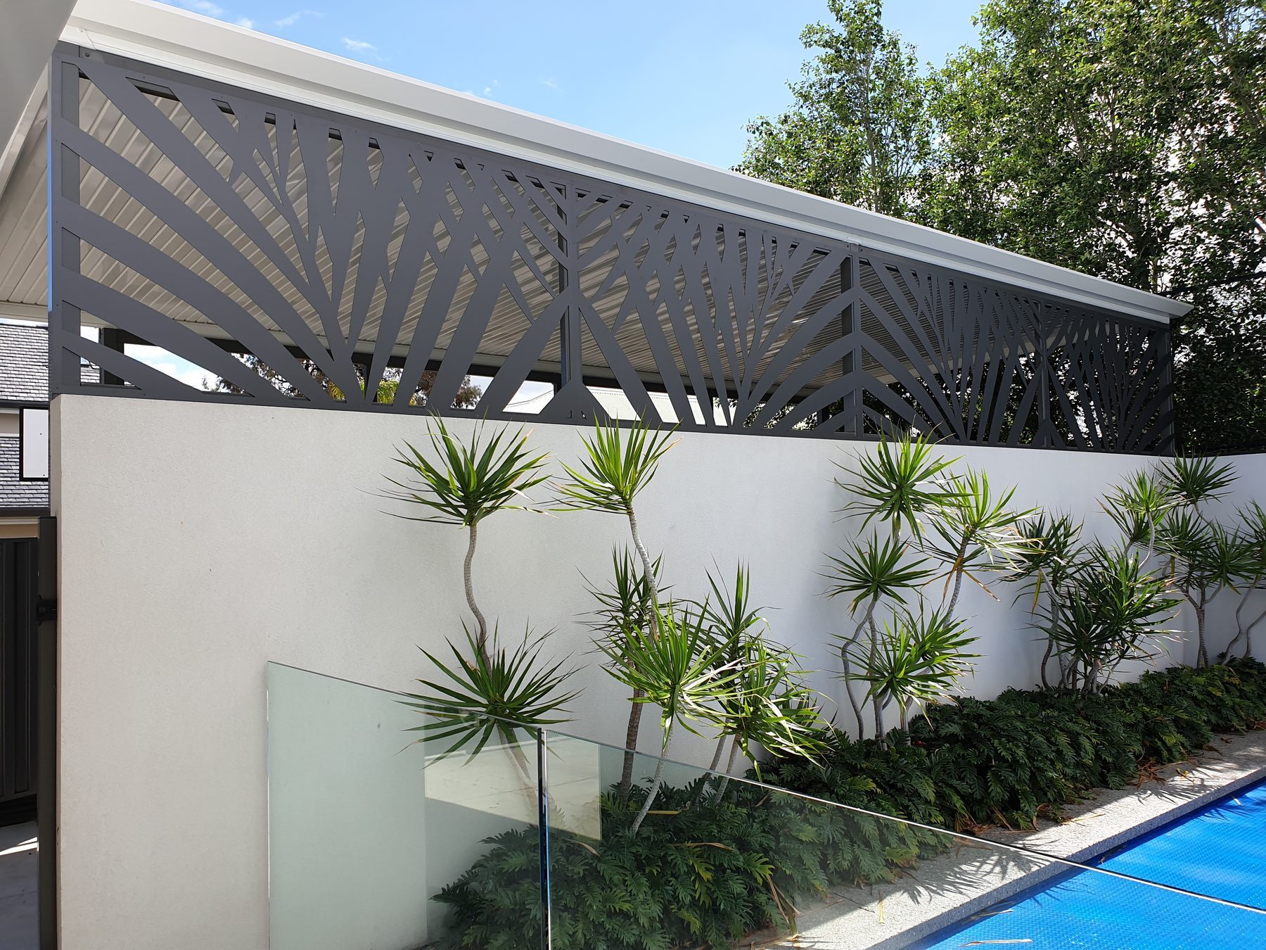 Laser cut screen panels beside a Perth pool