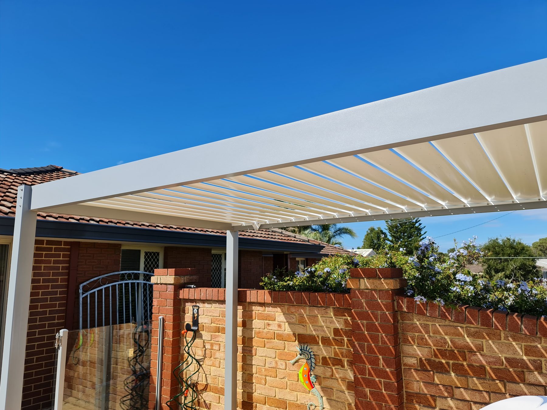 White louvred Outback Sunroof over a Perth patio