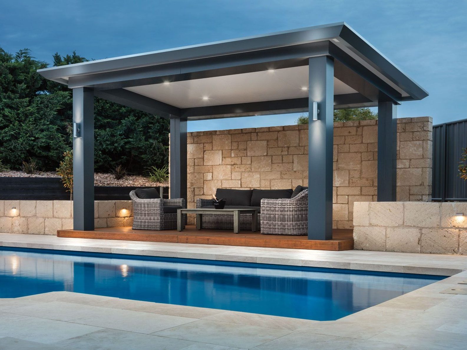 Stratco Pavilion Allure beside a pool with limestone walling